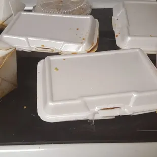 empty take out boxes on a stove