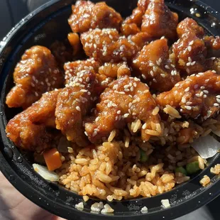 Sesame Chicken to go. Comes with rice and 1 egg roll