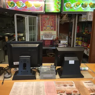 the counter and menus of a restaurant