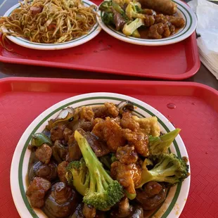 two plates of food on red trays