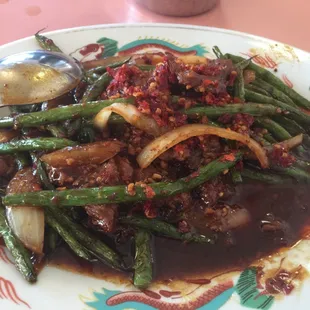 a plate of green beans and onions