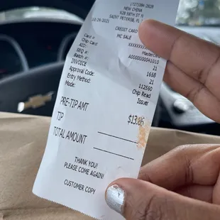a person holding a receipt in their hand