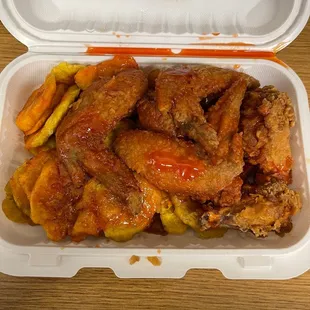 chicken wings and vegetables in a styrofoam container