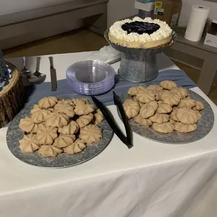 a table with cookies and a cake
