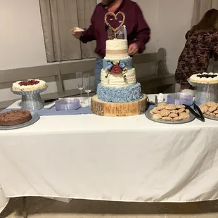 a man standing in front of a cake table