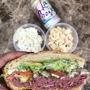 Hot Pastrami w/ provolone, avocado, everything, toasted sourdough | $8.49 (potato &amp; mac salad in the back)