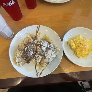 My food (Nutella crepe with chocolate milk and scrambled eggs with cheese.)