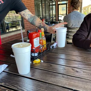 a man serving a hot dog