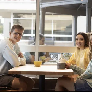 three people sitting at a table