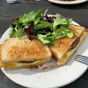 Breakfast sandwich with veggie sausage and salad