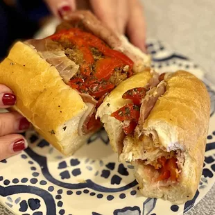 two hands holding a sub sandwich