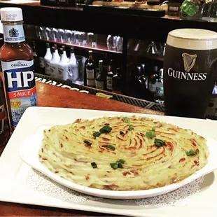 Homemade Shepherd&apos;s pie with a perfectly poured Guinness