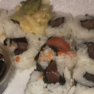 Poorly made dried up sushi the smear of siracha is the spicy tuna roll