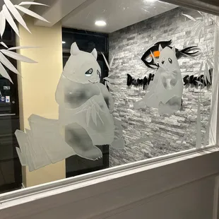 Ectched glass panda at entrance way