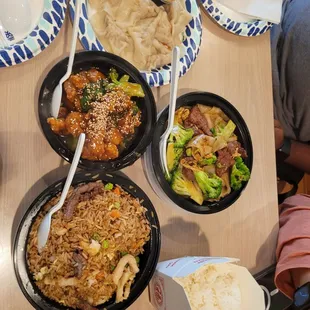 combination fried rice, sesame chicken, and a flat noodle dish with beef
