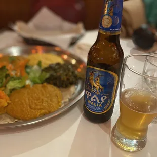 a beer and a plate of food