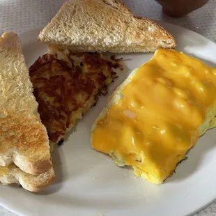 Omelet meat and cheese, hash browns and sour bread toast