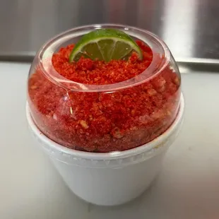 a close up of a strawberry and lime garnish