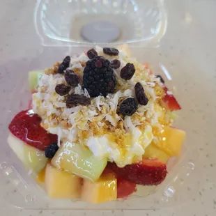 a fruit salad in a plastic container