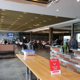 Receptionist and bar and view of their modernized and airy space.