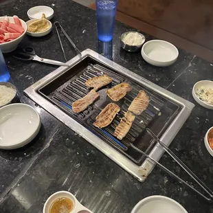 a grill with meat and vegetables on it