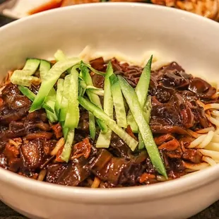 a bowl of noodles with meat and vegetables