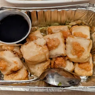 a tray of dumplings and a spoon