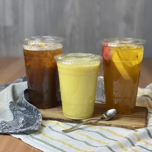 three drinks on a wooden tray