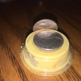 Hot mustard container and quarter for reference