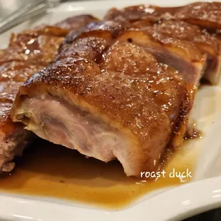 a plate of pork with gravy sauce