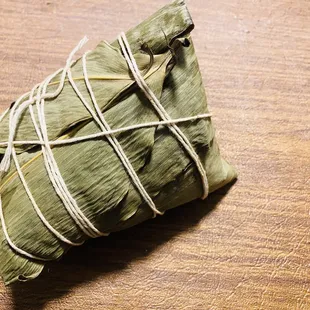a green leaf wrapped in bamboo