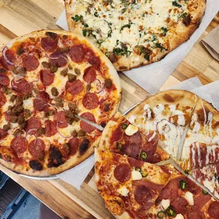 three pizzas on a table