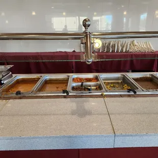 The whole selection of the lunch buffet, both vegetarians and non vegetarian.  White rice on the side.