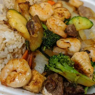 shrimp, broccoli, and rice in a styrofoam container