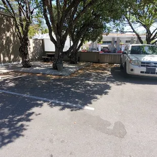 Patio with all the shade you want out front.  Also motorcycle parking to the left of that white SUV.