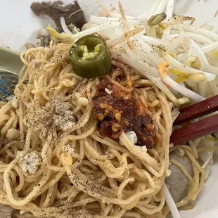 Added some spices to the noodles from the condiment caddy on the table.