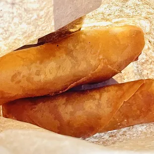 two hot dogs wrapped in paper
