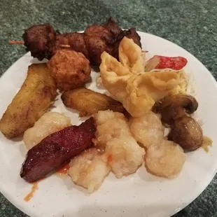 Plantains, fried chicken ball, shockingly tender chicken satay, crab rangoons, mushrooms, ribs, and walnut shrimp