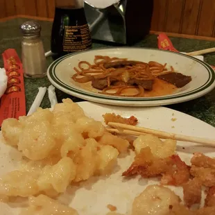 a plate of shrimp and shrimp skewers
