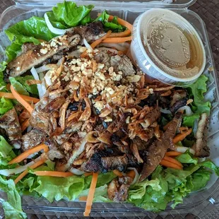 Take away grilled chicken salad. Dressing seemed to be a non-fatty liquid - so low calorie?. Good.