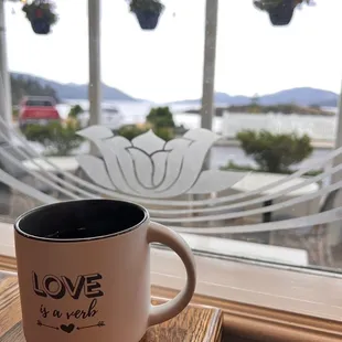 a cup of coffee on a window sill