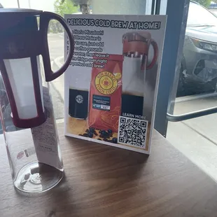 a cup of coffee next to a poster