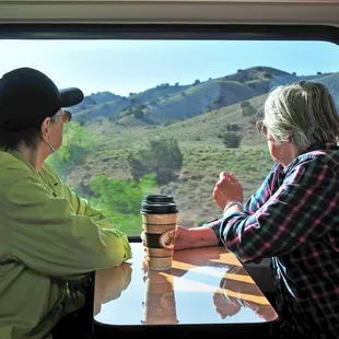 Seats with tables are located on the mezzanine and upper levels of the Rail Runner.