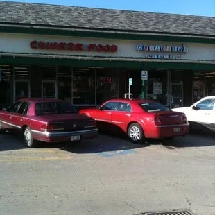 two cars parked in front of the store
