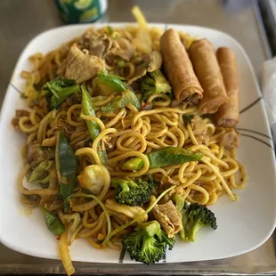 a plate of noodles with meat and vegetables