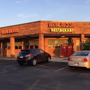 two cars parked in front of the restaurant