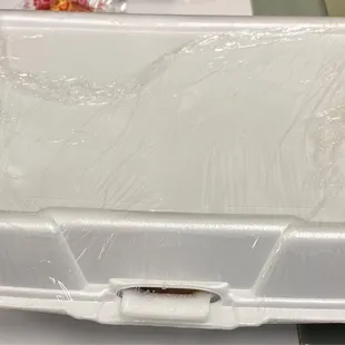 COVID procedures for the food containers. Staples and saran-wrap cover it entirely and keep it secure