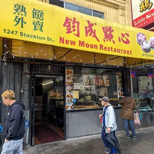 people walking in front of the restaurant