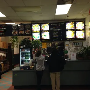 two people standing at the counter