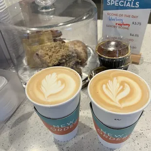Two lattes with lovely designs!
